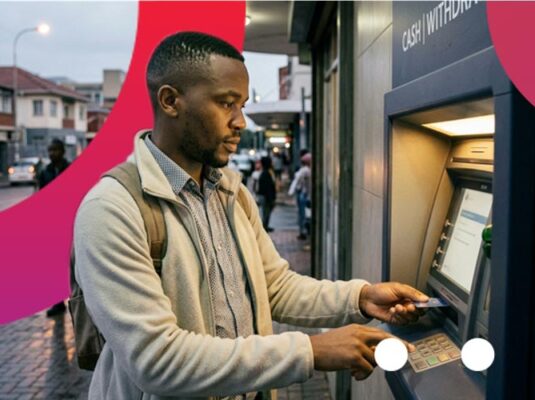Man withdrawing money from an ATM, which he acquired through a R500 loan from Atlas Finance.