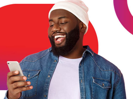Man smiling at his phone after securing a cash deposit with Atlas Finance's help.